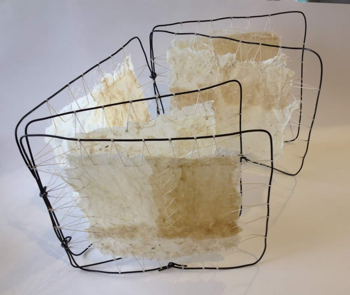 encaustic wax on fabric with wire frames as artist book